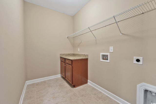 laundry room with hookup for an electric dryer, washer hookup, and cabinets