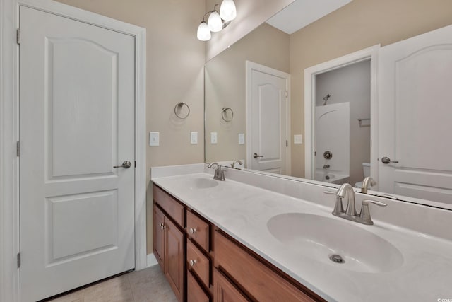 bathroom featuring tile patterned flooring, vanity, and toilet