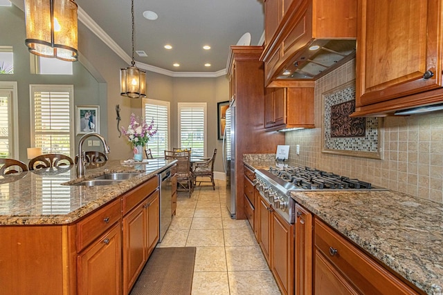 kitchen with appliances with stainless steel finishes, brown cabinets, under cabinet range hood, and a sink