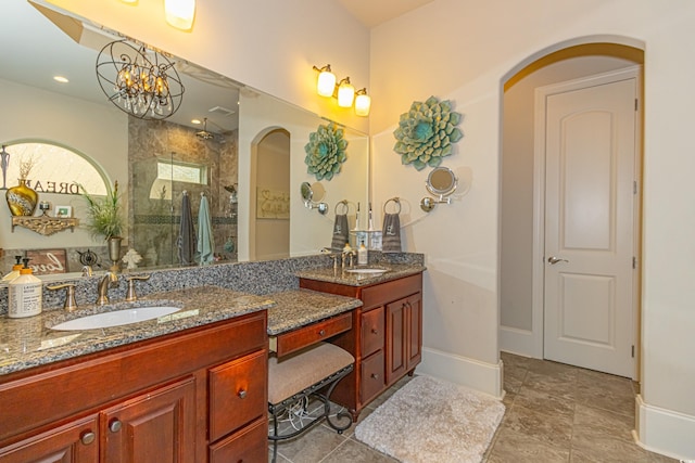 full bathroom with recessed lighting, baseboards, vanity, and a walk in shower