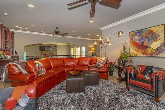 living area with recessed lighting, visible vents, arched walkways, and crown molding