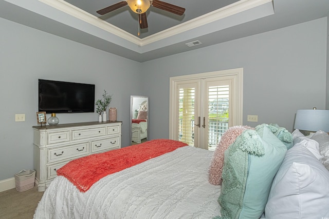 carpeted bedroom with visible vents, ornamental molding, french doors, a raised ceiling, and access to exterior