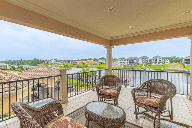 exterior space with a residential view, a water view, and a balcony