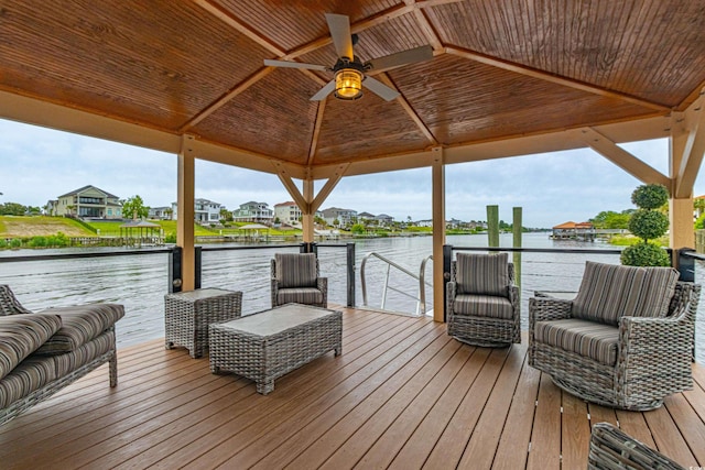 dock area with a gazebo and a deck with water view