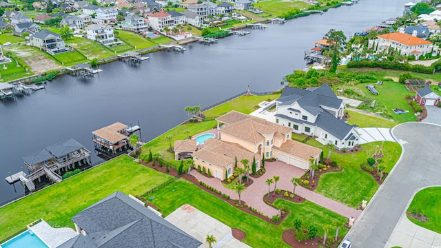 drone / aerial view with a residential view and a water view