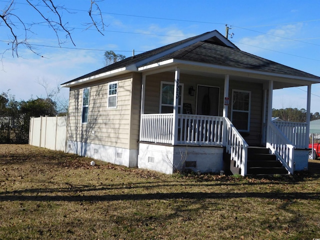 view of home's exterior featuring a yard and a porch