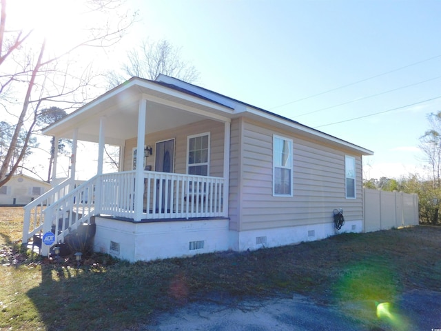 view of property exterior featuring covered porch