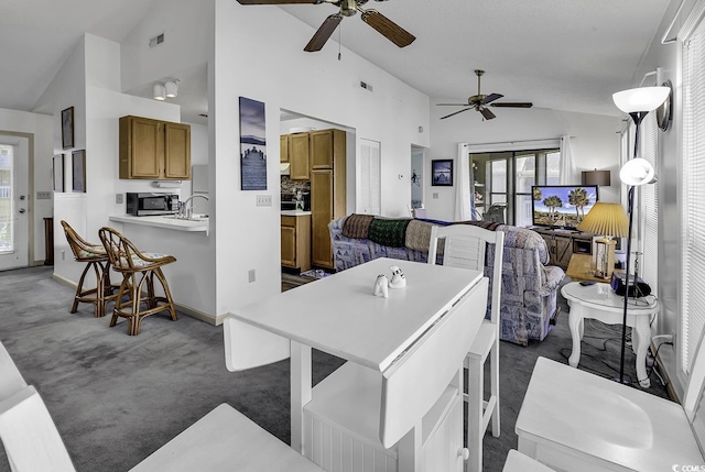 dining area with dark colored carpet, french doors, high vaulted ceiling, and ceiling fan