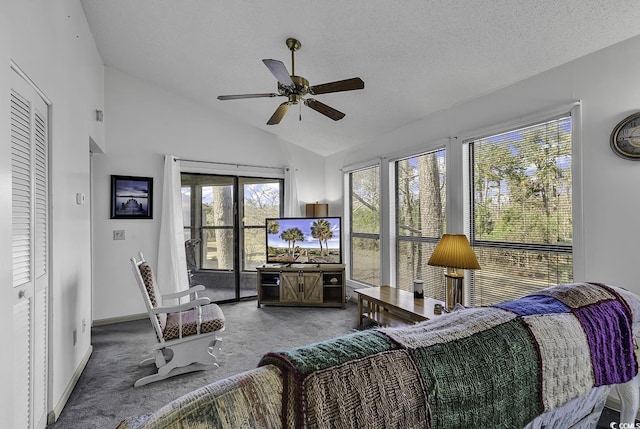 carpeted living room featuring a textured ceiling, vaulted ceiling, and ceiling fan