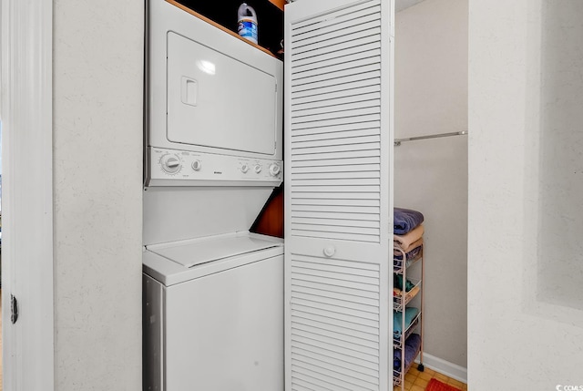 laundry room with stacked washer / drying machine