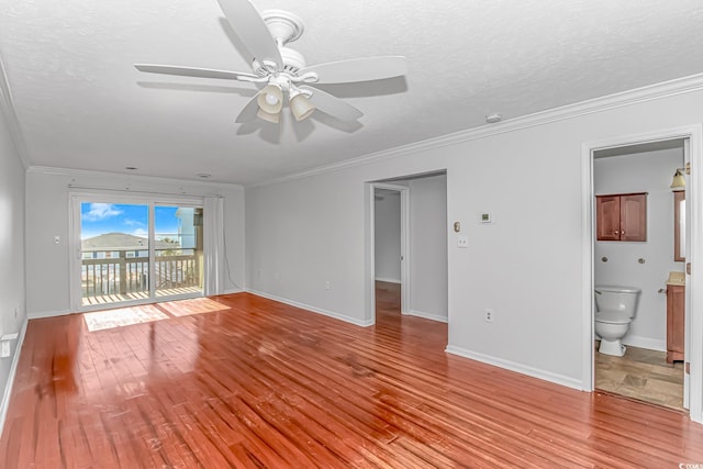 spare room with a textured ceiling, light wood-type flooring, ceiling fan, and crown molding