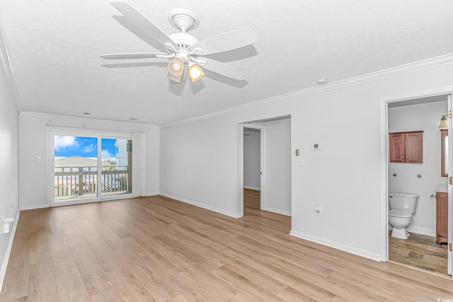 unfurnished living room featuring a textured ceiling, light wood-type flooring, baseboards, and crown molding