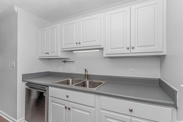 kitchen featuring dark countertops, white cabinets, a sink, and stainless steel dishwasher