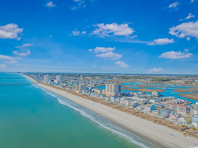 aerial view featuring a water view, a beach view, and a city view