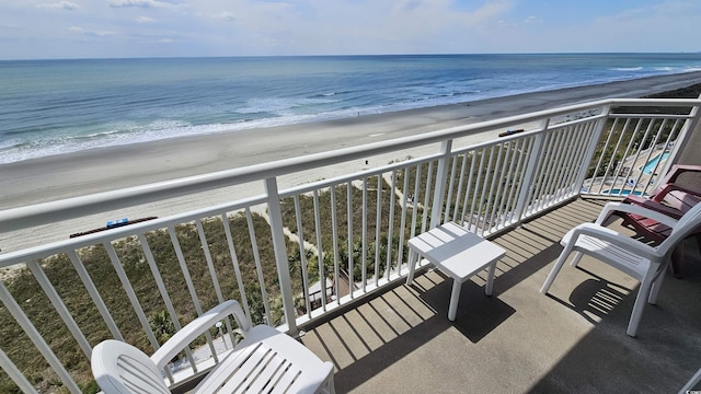 balcony featuring a water view and a view of the beach