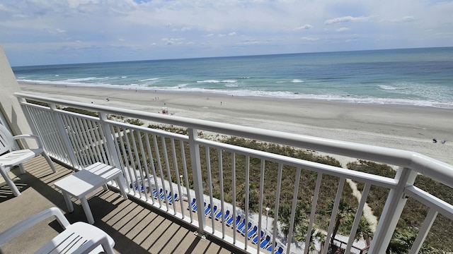 balcony with a water view and a beach view