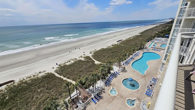 bird's eye view featuring a view of the beach and a water view