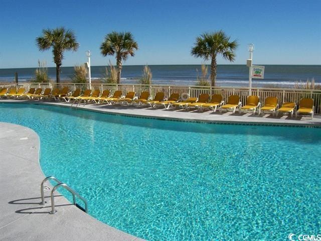 view of swimming pool featuring a water view