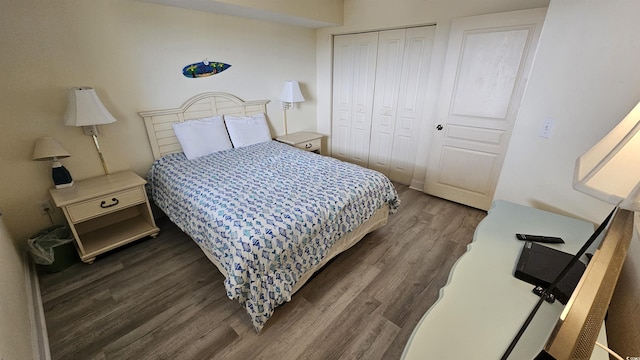 bedroom with a closet and dark wood-type flooring