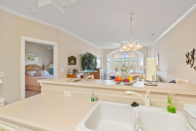 kitchen with crown molding, sink, and ceiling fan with notable chandelier