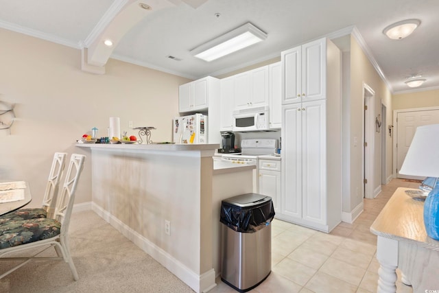 kitchen with white cabinets, kitchen peninsula, white appliances, and ornamental molding