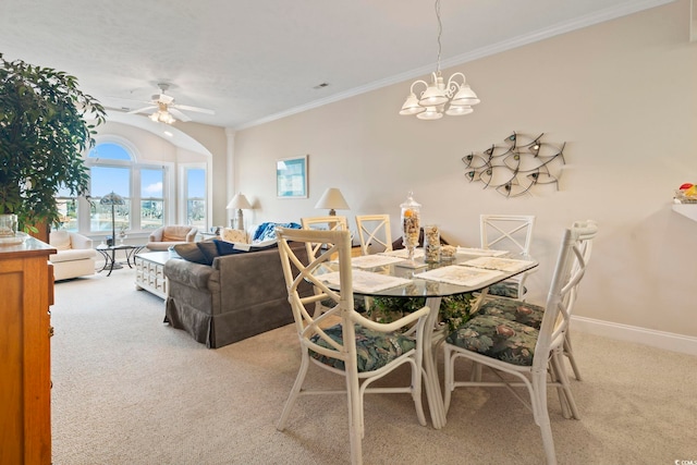 dining area featuring carpet flooring, ceiling fan with notable chandelier, and ornamental molding