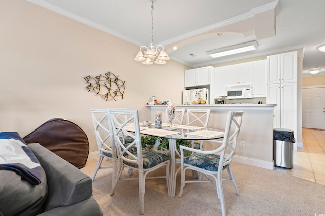 dining room featuring a chandelier, light tile patterned floors, and crown molding