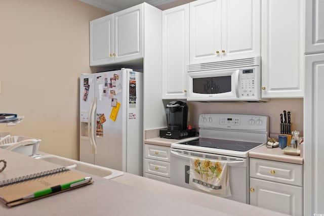 kitchen featuring white cabinets, white appliances, and crown molding