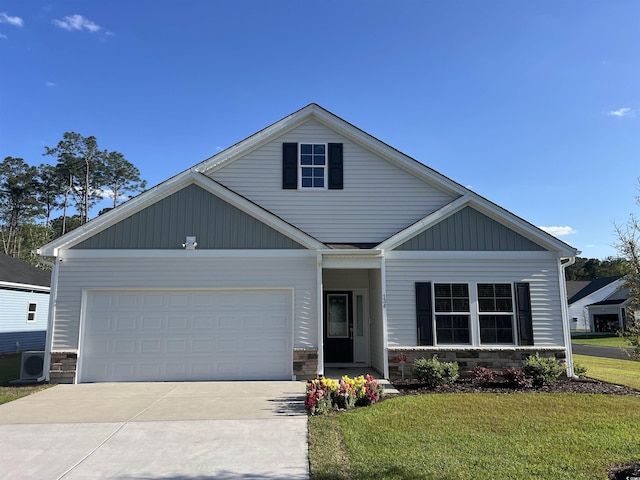 view of front of property with a front yard, ac unit, an attached garage, stone siding, and concrete driveway