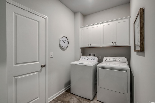 laundry room with cabinets and washing machine and dryer