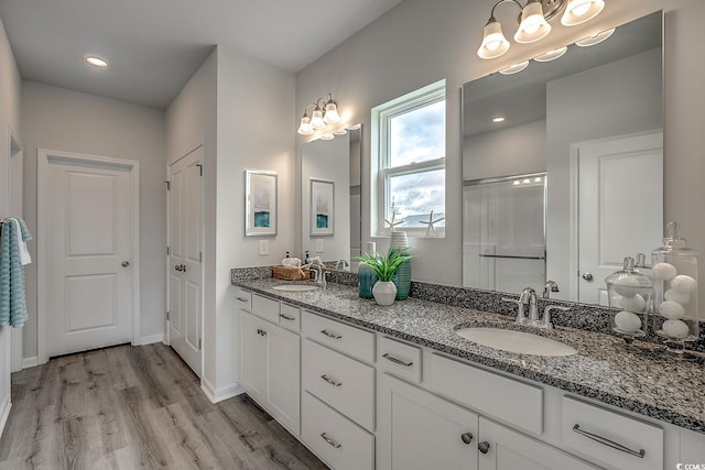 bathroom featuring wood-type flooring, vanity, and walk in shower