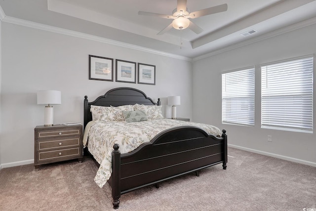 bedroom with visible vents, baseboards, a raised ceiling, and carpet
