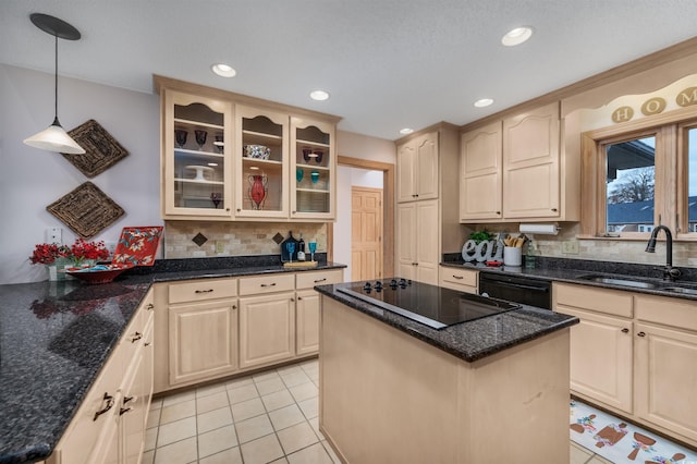 kitchen with sink, a center island, hanging light fixtures, dark stone counters, and black appliances