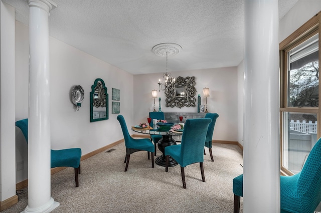 dining space with carpet flooring, a notable chandelier, a healthy amount of sunlight, and decorative columns