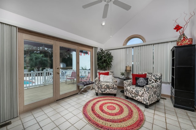 sunroom featuring ceiling fan, a healthy amount of sunlight, and lofted ceiling