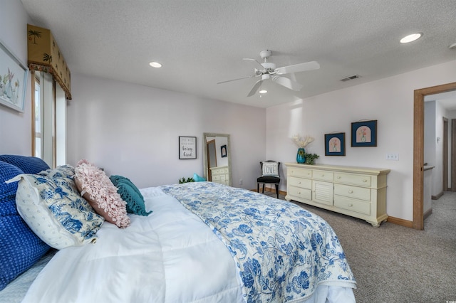 carpeted bedroom with a textured ceiling and ceiling fan