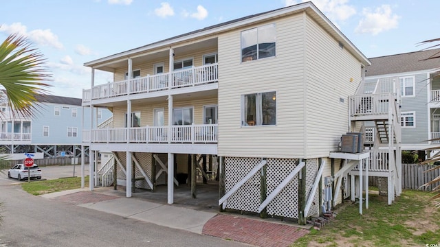 rear view of property with a carport