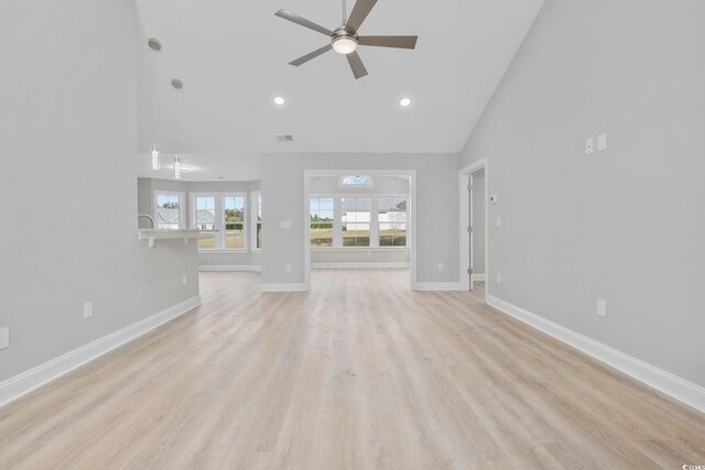 unfurnished living room featuring ceiling fan, high vaulted ceiling, and light hardwood / wood-style flooring