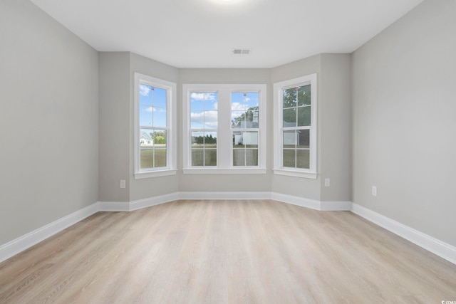 spare room with light hardwood / wood-style flooring