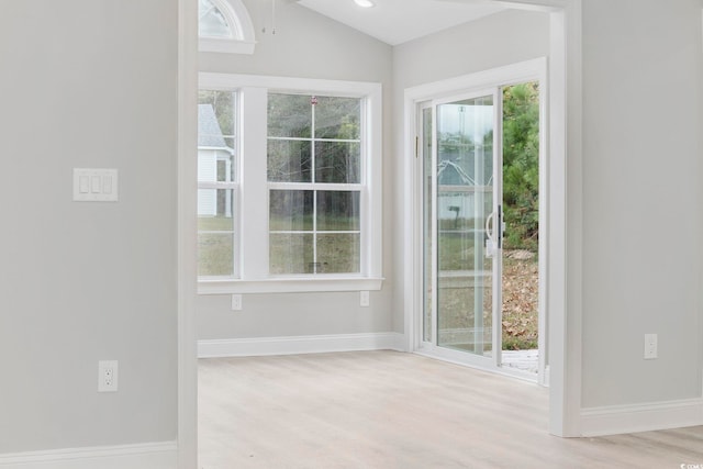 entryway with lofted ceiling and light wood-type flooring