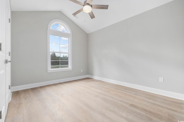 empty room featuring lofted ceiling, ceiling fan, and light hardwood / wood-style flooring