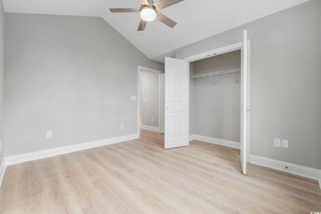 unfurnished bedroom with vaulted ceiling, light hardwood / wood-style floors, a closet, and ceiling fan