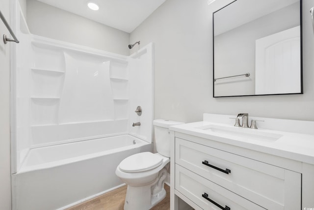 full bathroom featuring vanity, bathtub / shower combination, hardwood / wood-style floors, and toilet