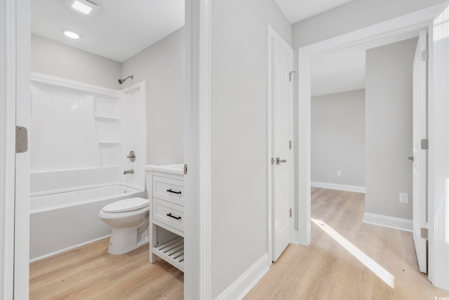 full bathroom featuring wood-type flooring, vanity, shower / bathtub combination, and toilet