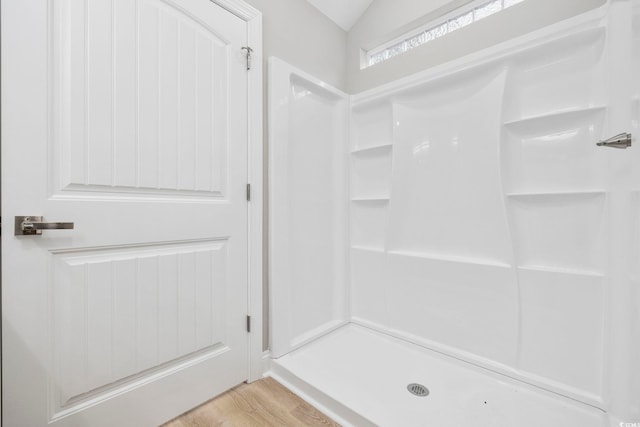 bathroom with wood-type flooring and a shower