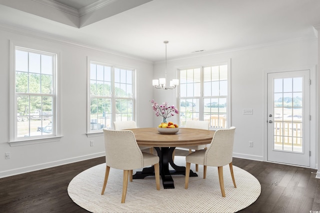 dining area featuring a chandelier, dark hardwood / wood-style flooring, and crown molding