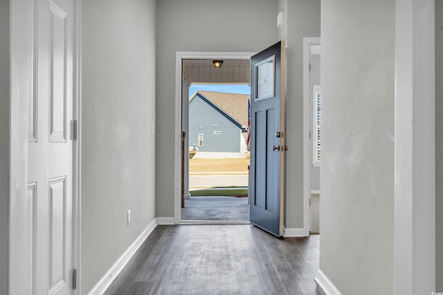 foyer with wood finished floors and baseboards