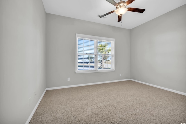 empty room featuring carpet flooring, a ceiling fan, and baseboards