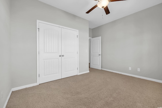 unfurnished bedroom with a closet, carpet flooring, and baseboards