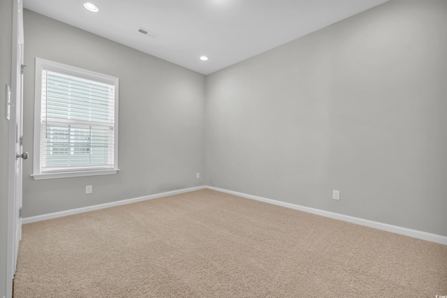 carpeted spare room with recessed lighting, visible vents, and baseboards